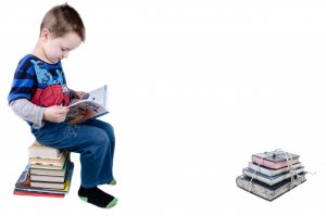 A kid's reading some of the best books for 5 year olds. 