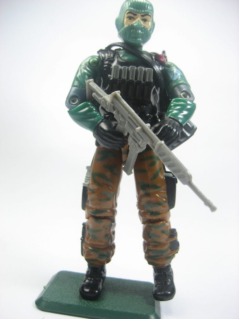 A GI Joe toy holding a gun. Many GI Joe toys have accessories.