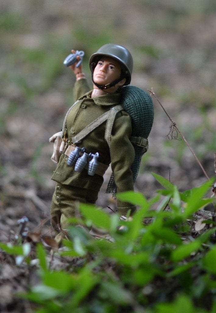 A GI Joe toy holding a grenade