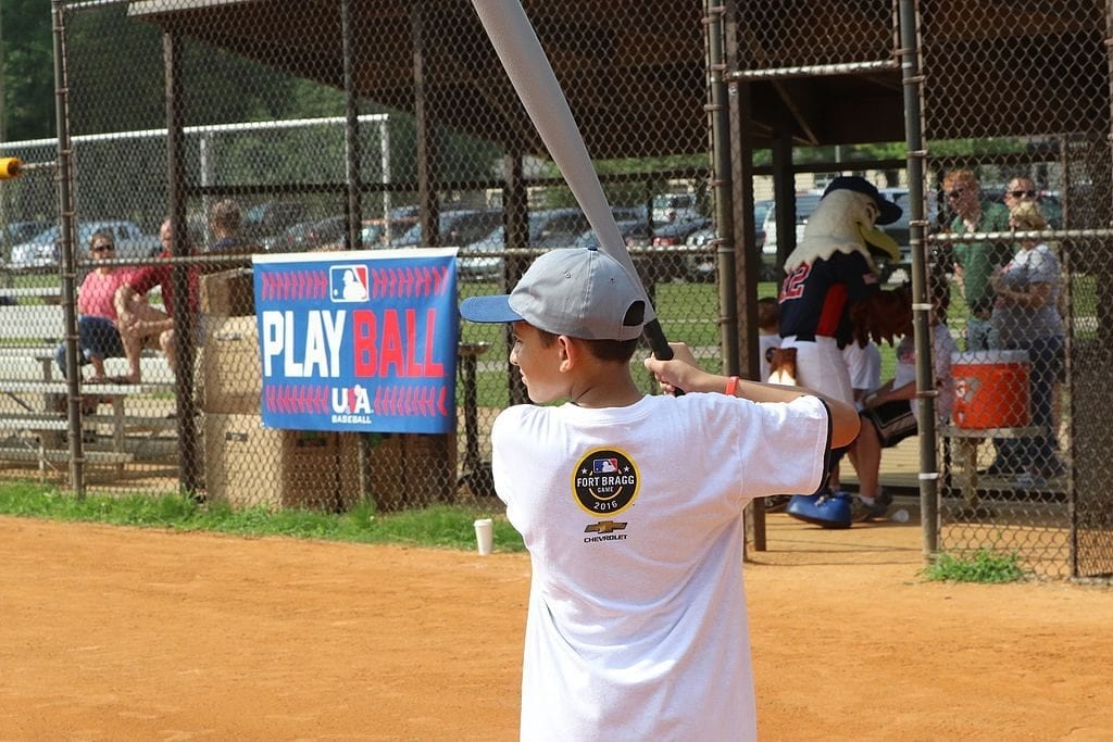 A baseball bat: a good gift for an 11 year old boy Boy ready to play baseball, one of the best outdoor toys for 11-year-old boys.