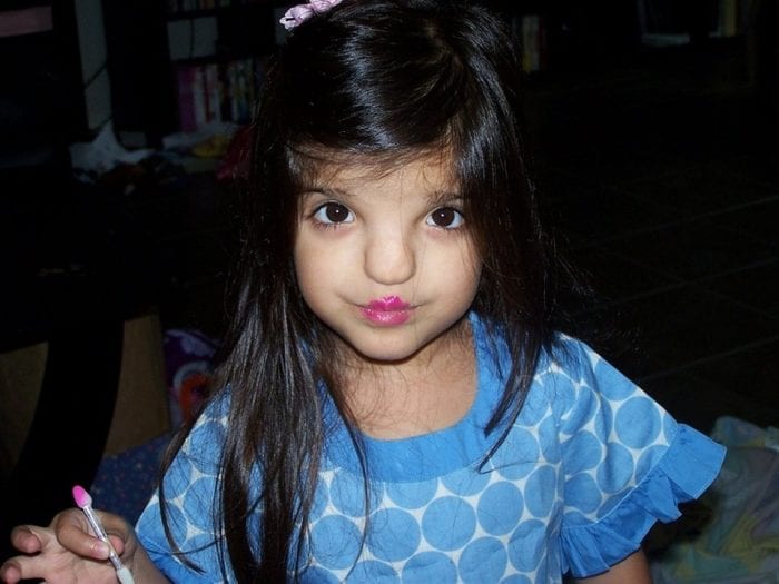 little girl wearing lipstick