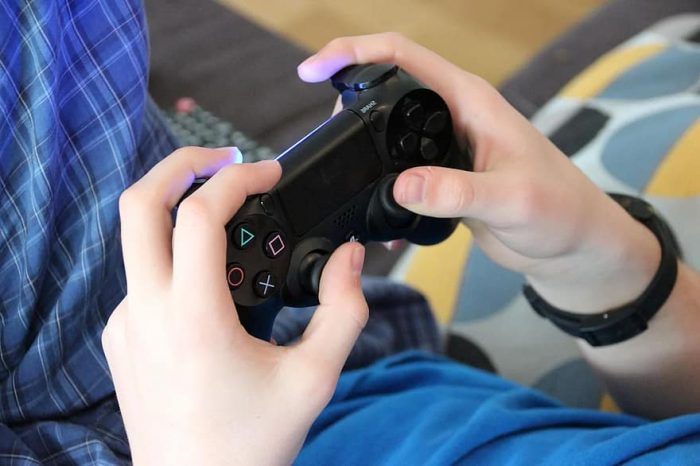 A child holding the controller of one best ps4 games for kids. 