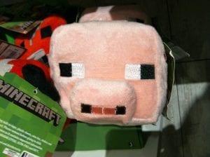 A Minecraft plush piggy with pixelated features.
