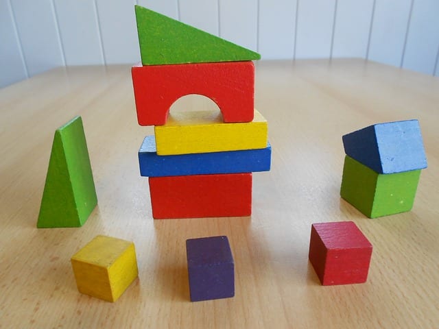 Wooden blocks are toys that encourage imaginative play.