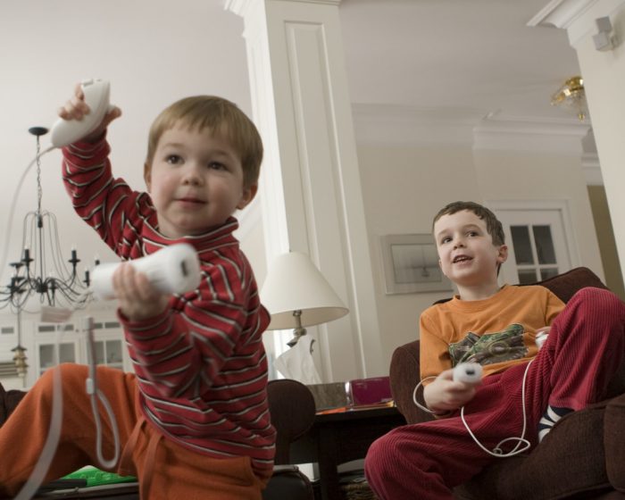 kiddos enjoying the nintendo Wii console playing together having fun