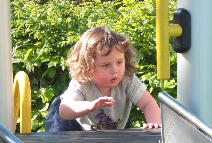 A young girl is playing with the toddler climbing toys. This climbing toy and activity can be a lot of fun for many toddlers. They can improve their climbing ability. Of course, parents still need to help their toddlers when climbing to avoid problems or accidents while playing on the playground or with this climber toy. 