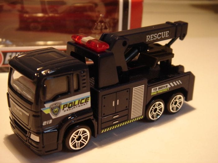 Toy Truck: Black police department rescue toy tow truck for kids with 'To Serve and Protect' slogan.