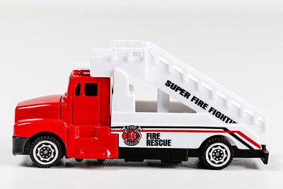 A firefighter truck toy. A red and white toy.