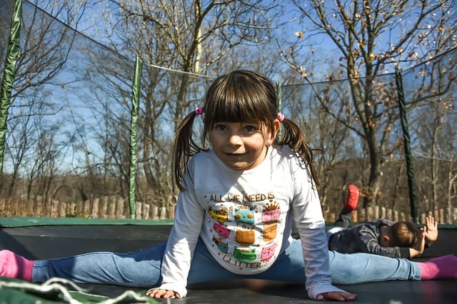 a girl playing inside a trampoline