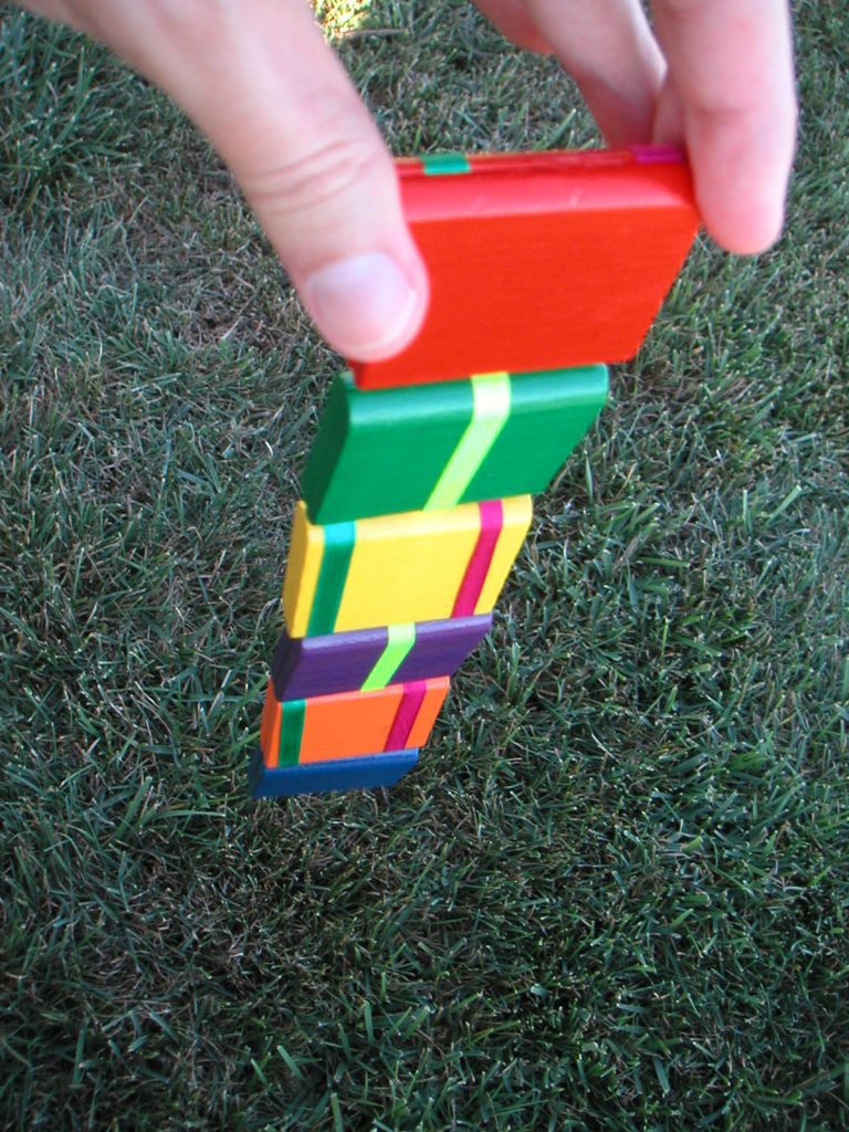 a stack of ladder toys on the grass