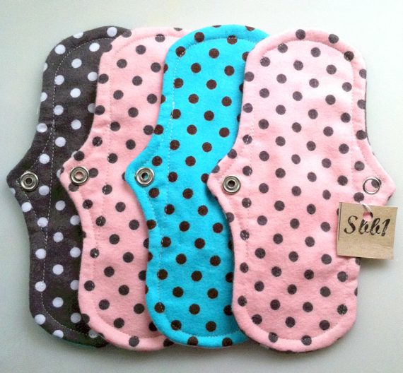 postpartum: 4 dotted reusable best postpartum pads arranged together in one set. 