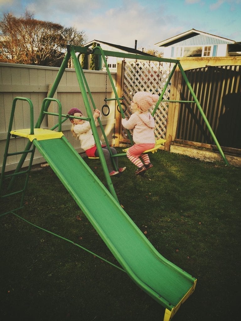 2 little kids having fun in the swing. It's an impressive swing set, and it's very affordable, meaning that it will provide the best entertainment for children that are especially on the younger end of the spectrum. One of the most suitable options indeed.