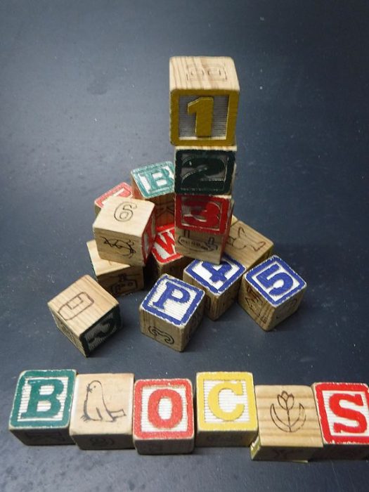 wooden blocks - As your baby is growing, their sense of fine motor skills starts to improve. Fine motor skills include using their fingers, and wooden alphabet blocks require some tricky finger work. For example, it can involve your baby placing their fingers around the edges while trying to prevent their fingers from slipping.