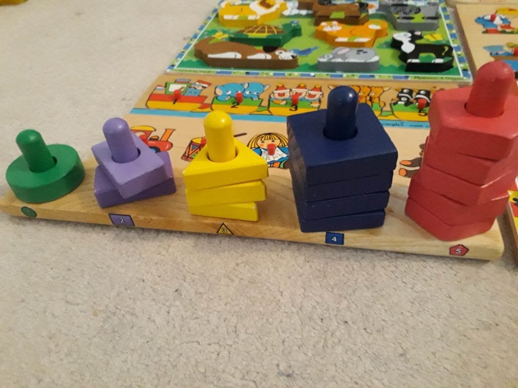 green, purple, yellow, blue, and red with wooden stacks that kids can play at home which is safe for a baby to play with