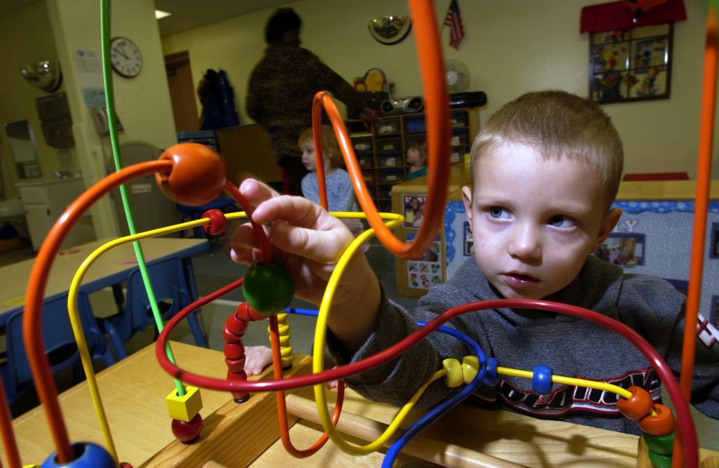 A young child engaged in solving a puzzle maze is an effective way to boost motor abilities. Such games prove immensely beneficial as they deliver entertainment while helping refine fine spatial skills. 