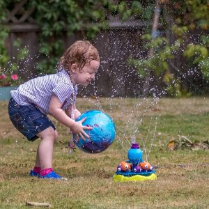 A child playing with the best sprinkler in their lawn. It is also good for kids.