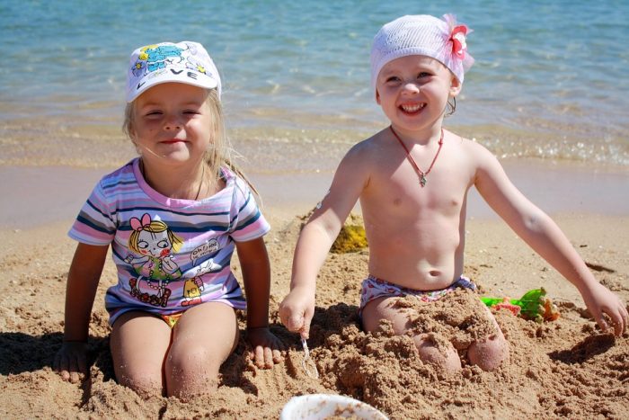 Two kids having fun in the beach