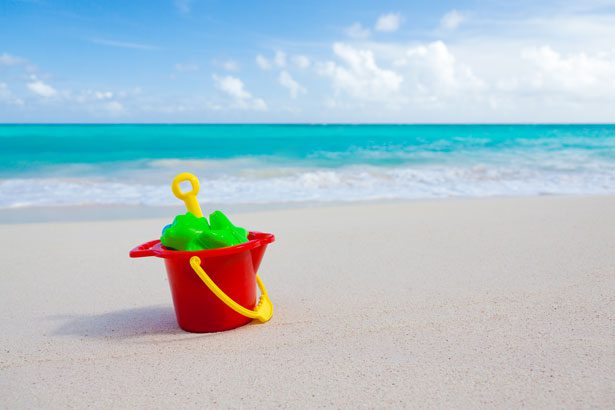 A red pail for playing in beach sand.