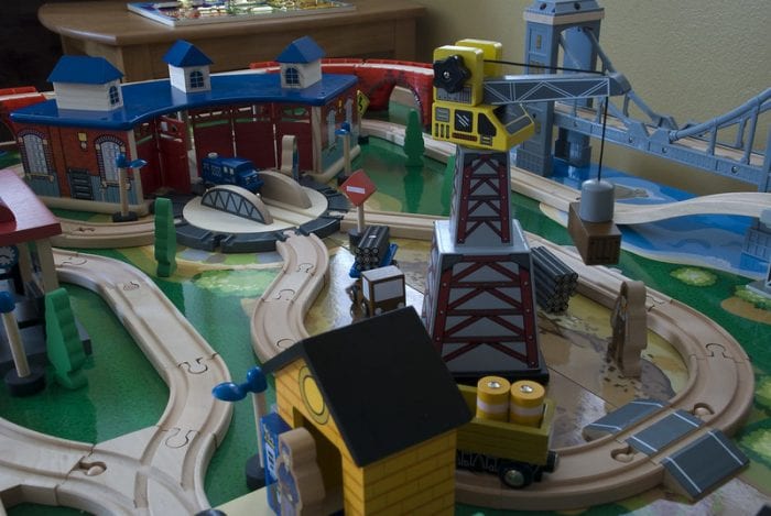 The railroad train is made of wood. Playing line train table delivers hours of fun for the kids. Try it out with your child. A big train play set for kids to enjoy