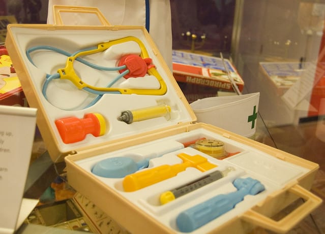 There is a kids' doctor kit. The kit includes a bottle, a syringe, a stethoscope, and other related doctor kit tools or doctor equipment.