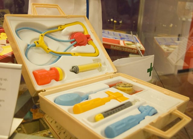 There is a kids' doctor kit. The kit includes a bottle, a syringe, a stethoscope, and other related doctor kit tools or doctor equipment. 