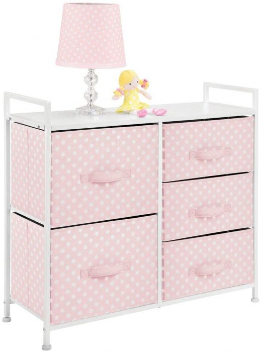 A pink baby dresser. It has a polka dot design. The design of the dresser matches with the design of the lamp. 