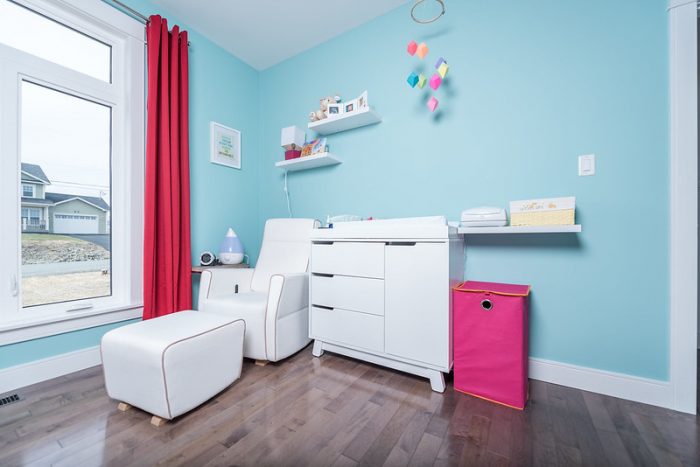 A modern-looking baby's room. All the items you see are modern and match the theme of the room. 