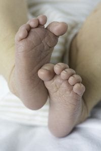 This captivating image shows the irresistibly cute baby toes, which appear remarkably smooth, pinkish, and soft.