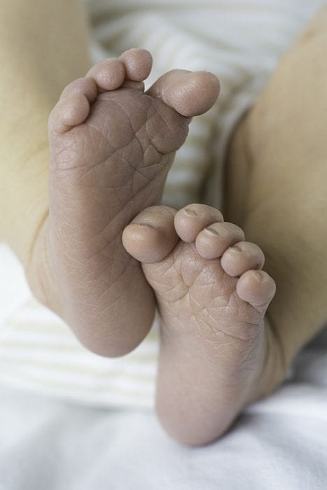 A picture showcasing a toddler's feet alongside top-tier cutting tools specifically designed for young children's dexterity and safety requirements. These exceptional tools cater for the smallest of fingers, ensuring an excellent grip and ease of use during their early years of development.