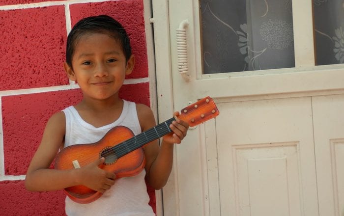 kid holding a ukulele