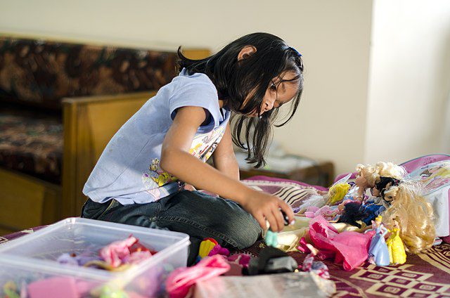 Girl playing with her toys for fun