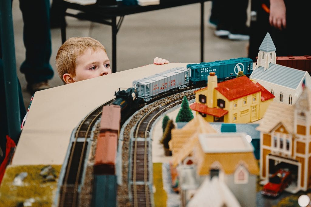 A young kid having fun with a big play set. 