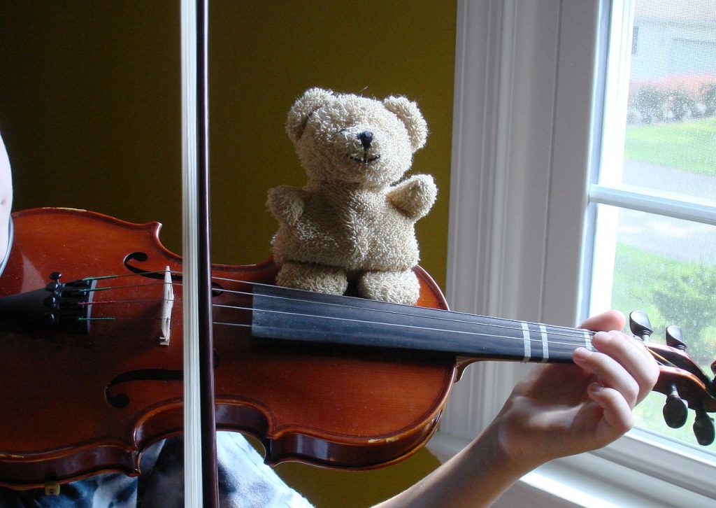 Kids love musical instruments and they would surely love a toy violin! The cute bear is sitting on top of the violin. These are such great gift ideas. More details in the article.