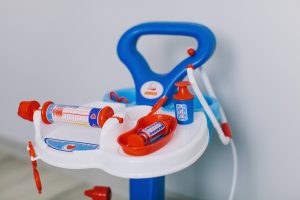 Doctor Kit for kids. This set of doctor kit toys includes a stethoscope, syringe, bottles, and a ballpen. It also follows a blue, orange, and white color scheme. 