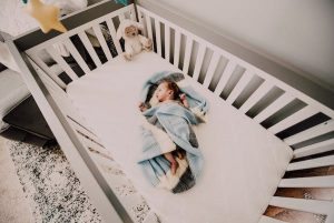White wooden baby cribs. Cozy room.
