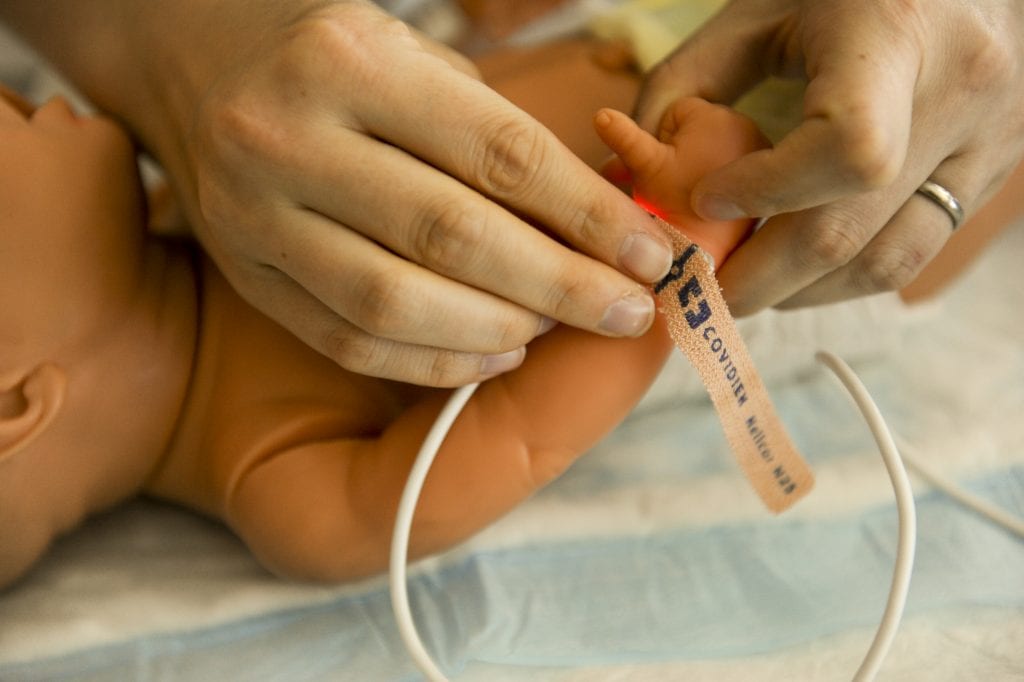 This shows how device for newborn is being used. This is also important when checking infant's health. Some of these baby's breathing heart rate checkers come in the form of a finger checker to show the heart rate child will have along with the breathing levels.