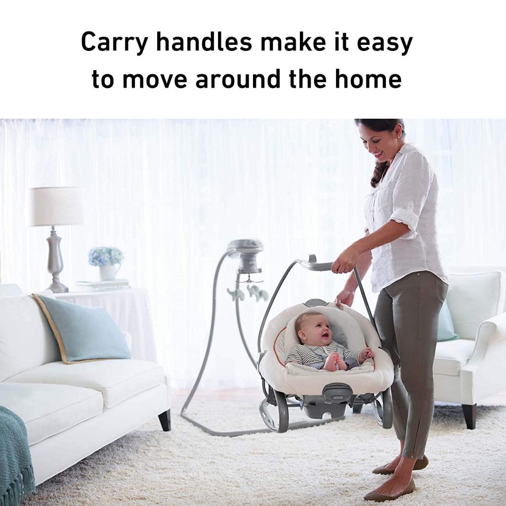 A mother is holding a swing w/ a cute little baby on it.