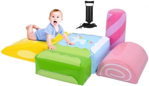 A kid is playing with 5 colorful baby blocks. 