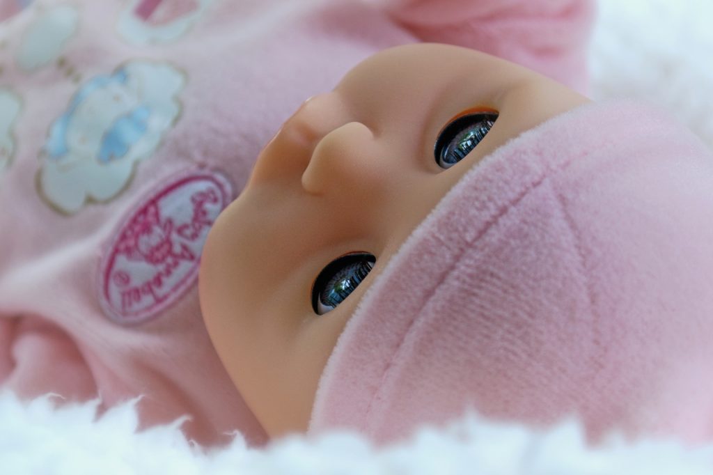 Choose the best baby doll for your baby, very cute shining black eyes and pink bonnet with pink clothes, very realistic looking with small nose and a fashionable clothing