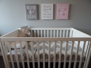 Best baby crib manufactured in the USA, set against a gray room