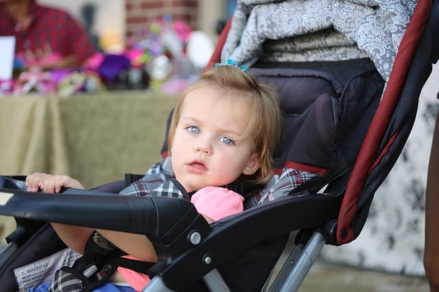 a cute baby girl in a Nuna stroller. Maxi-Cosi Zelia 2 Modular Travel System is innovative and designed to look fashionable.