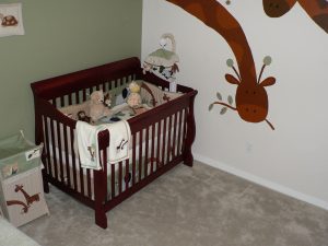 One of the best black baby cribs is placed in the corner of a cozy room.
