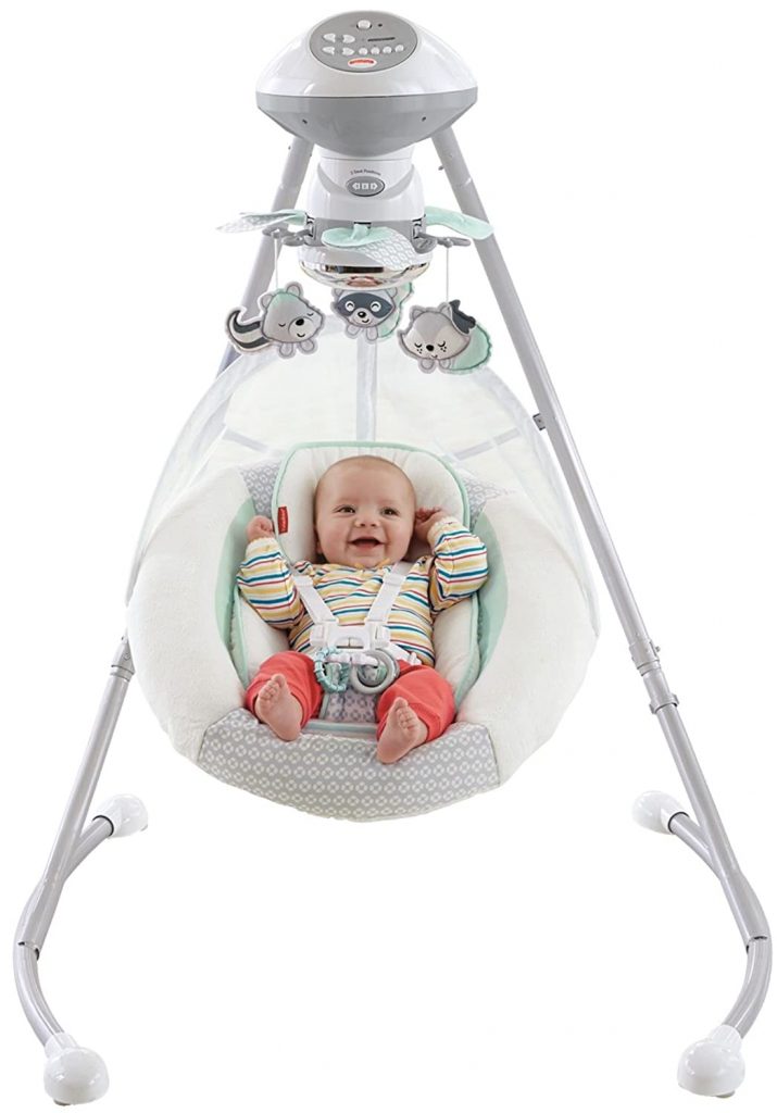 A cute little baby in a striped sweatshirt is swaying in Fisher-Price Moonlight Meadow. 