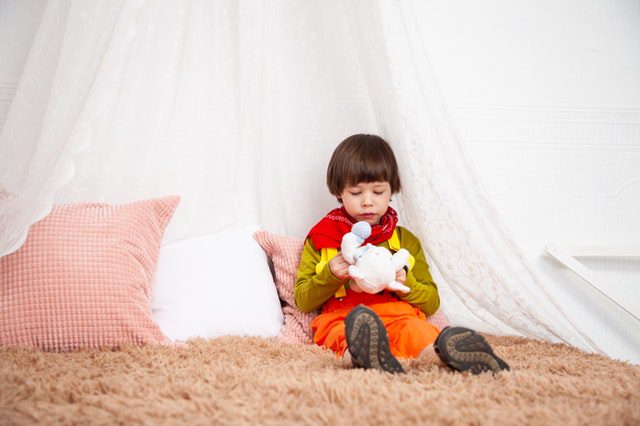 a boy sitting on a mattress. Finding good mattress for your child can be hard at times. Another good question to ask yourself is the thickness.