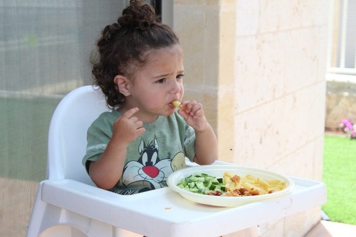 A toddler with her meal