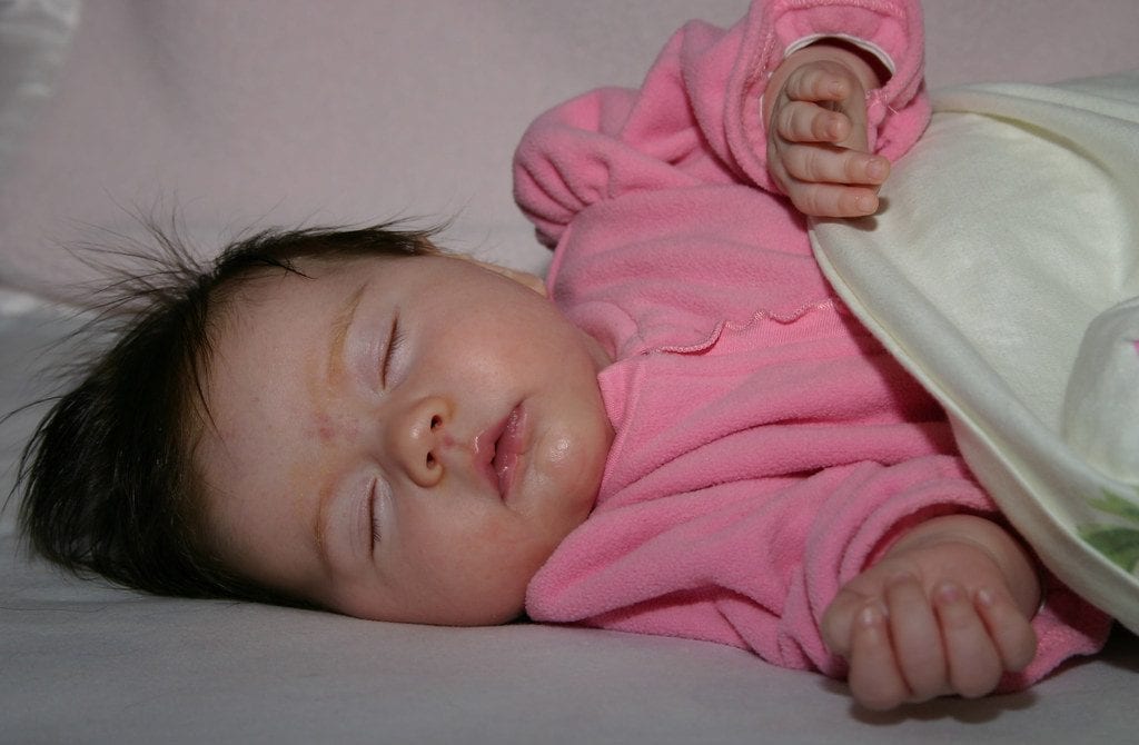 A cute baby sleeping on bed. Baby ready for night weaning.