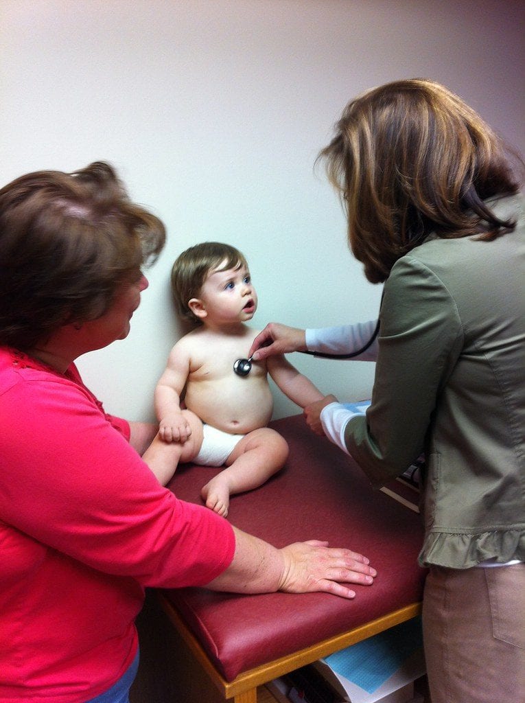 a baby being checked up