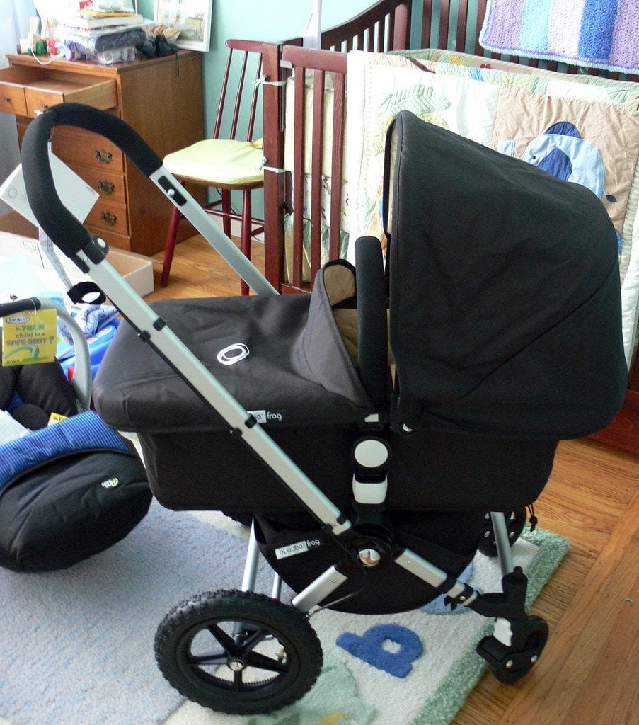 Bugaboo Bee Review: A Bugaboo Bee stroller in a home nursery setting, with a crib and children's furniture in the background, highlighting that the Bugaboo Bee is suitable for indoor and outdoor use.