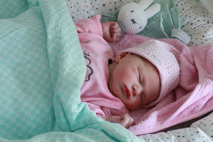 A baby sleeping in their comfortable position.