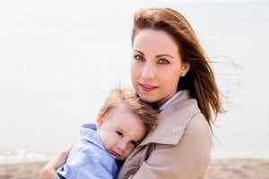 a happy mom and baby posing for a camera picture